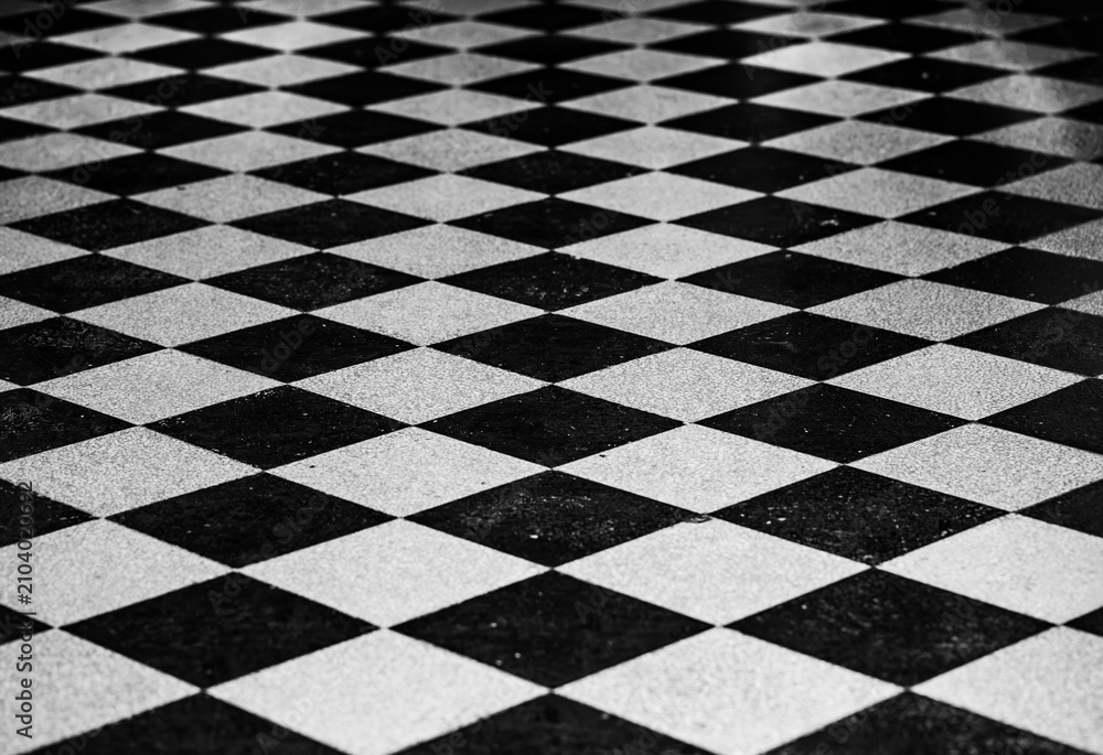 Obraz premium Checkered black and white diamond tiled floor pattern