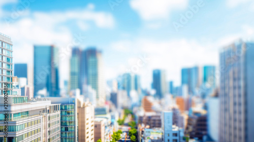 Naklejka ビル群と青空が広がる都会の風景をミニチュア風に描いた背景素材