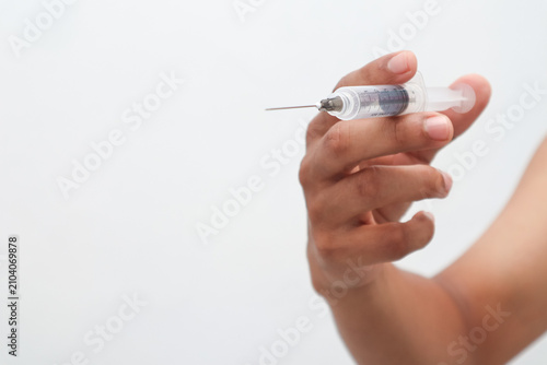 Obraz na plátně Hand Holding Syringe with Needle and Medication