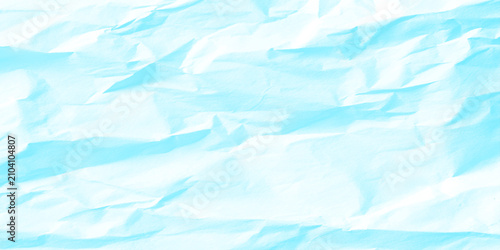 Crumpled light blue paper texture background with creases and folds for design
