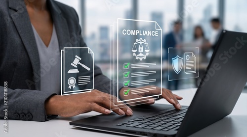 Business professional working on laptop with compliance checklist hologram, legal regulations and data security protection concept for corporate governance.