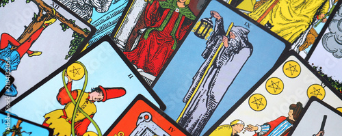 Big pile of different classical tarot cards on table. Pattern of tarot cards with traditional standard meanings