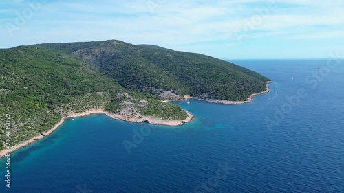 Aerial view of a serene Croatian island coastline. Lush green hills meet the crystal-clear turquoise waters of the Adriatic Sea. Perfect summer escape! Beach Grabrovica