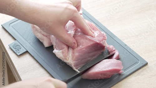 Cutting Raw Meat into Pieces During Food Preparation in Home Kitchen, 4K