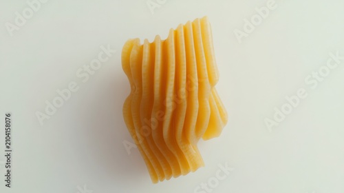 Close up Of Yellow Rippled Pasta On White Background