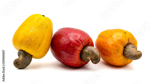Three Ripe Cashew Apples Yellow Red and Orange Color with Raw Nuts Isolated on White Background