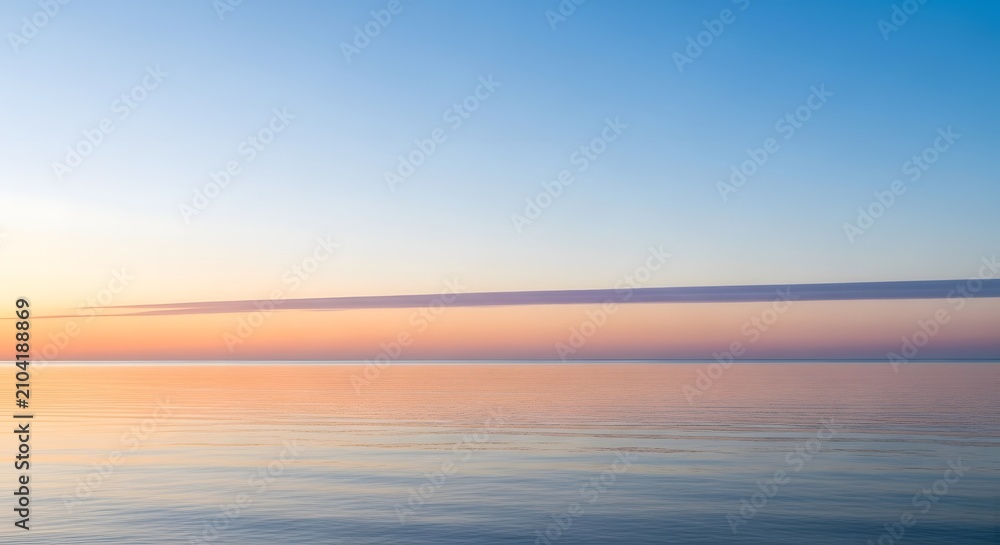 Fototapeta premium Calm ocean horizon at dawn with soft pastel sky and reflection on tranquil water surface