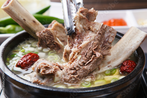 Korean short rib soup galbitang with glass noodles green onion and jujube in stone bowl