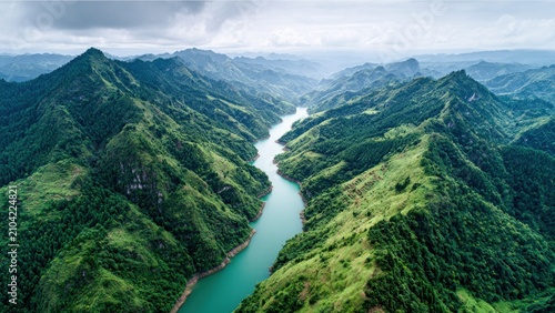 Serene river valley nestled within verdant mountain range