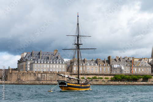 High tide in Brittany with view toward walled city of Saint-Malo. Coastal Atlantic landscape with boats and dramatic tidal range of Emerald Coast, France, boat travel