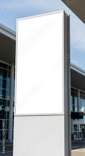 Vertical blank pylon sign mockup at modern airport terminal entrance