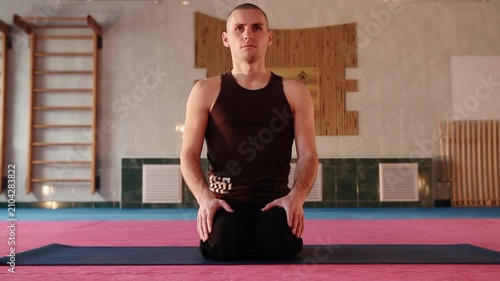 Male yogi siting in seiza pose meditation posture breathing in hall showcasing dedication to physical and mental balance Healthy concept living motivation achieving fitness goals through advanced yoga