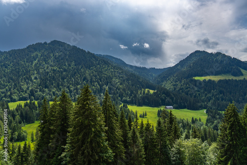 Bregenz forest in Austria on a cloudy summer day. alpine farmhouse under a tightrope under changing weather. holiday destination for hiker and climber and in winter skiing