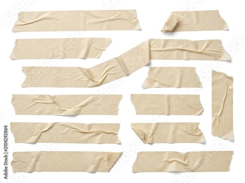 Collection of beige masking tape strips featuring wrinkled textures isolated against a solid white studio background