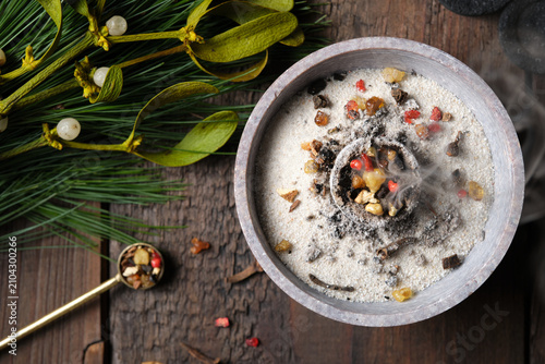 Fotografie Close-up of burning incense with smoke (frankincense, myrrh and herbs) in a cens
