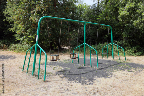 empty urban playground in a summer drought with dead brown grass
