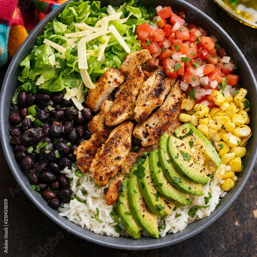Delicious burrito bowl with grilled chicken, black beans, corn, avocado and fresh salsa