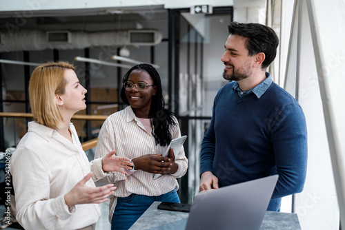 Group of people talking in a modern office during a work meeting in the afternoon