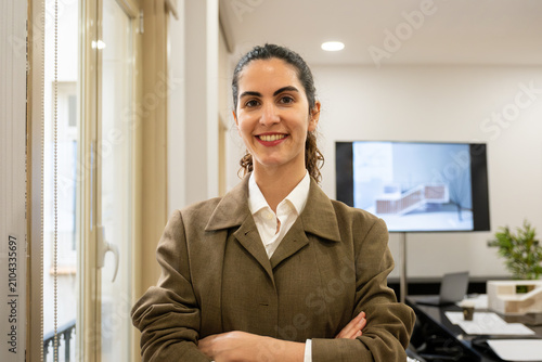 Obraz na plátně Businesswoman smiling, portraying confidence and professionalism in modern offic
