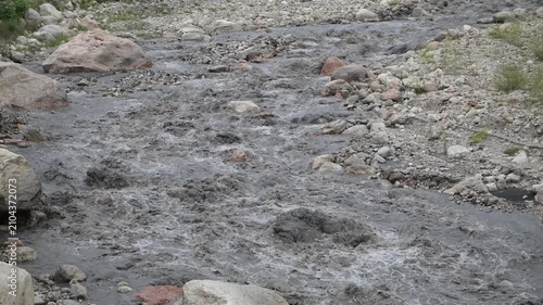 Background of a mountain river with strong flow, cloudy after precipitation