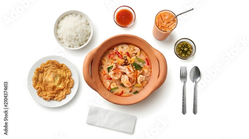 Top view of Thai meal set with Tom Yum Goong, omelet, and rice on white background, creative food art illustration
