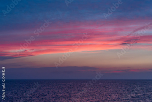 Vivid pink and purple sunset sky over Lake Michigan near Holland Michigan
