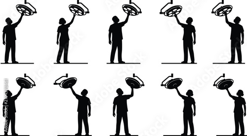 Foto Medical surgeons adjusting operating room lights silhouettes