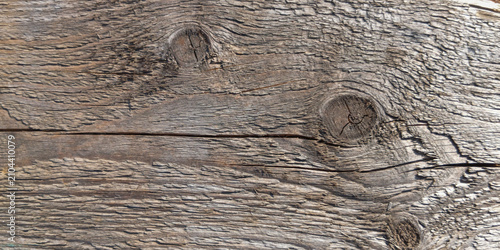 Принти на полотні Close-up of weathered grey wood plank texture with prominent knots and cracks, rustic timber background