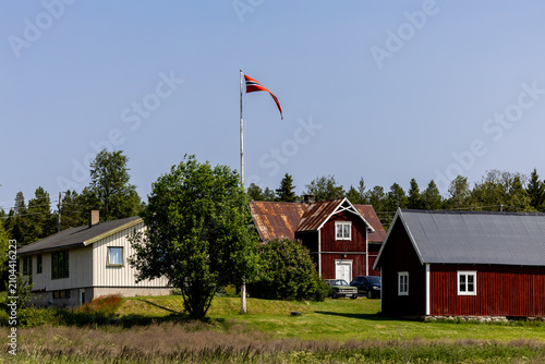 Tableau sur toile Drevsjo, Norway A farmhouse in the forest with a Norway flag.