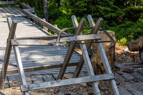 Photography Sarna, Sweden A sawhorse and saw in the Fulufjallet National Park for tourists to chop firewood for a fire