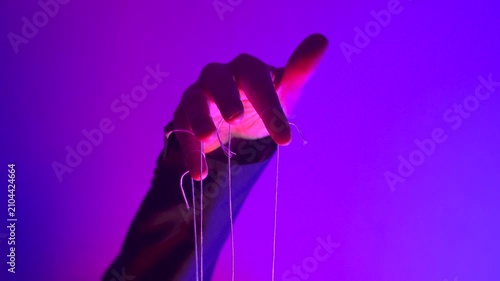 Hand with Puppet Strings in Neon Pink Light — Control and Manipulation Concept