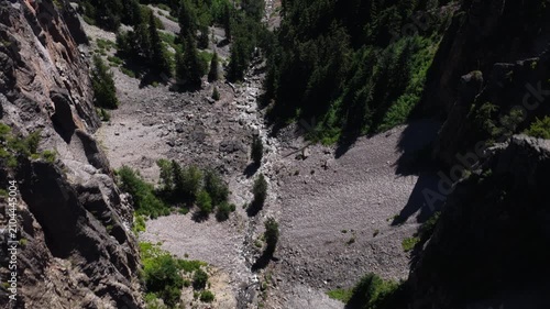 Aerial of North Fork Clear Creek canyon river gorge in Wenatchee National Forest with steep forested cliffs in central Washington