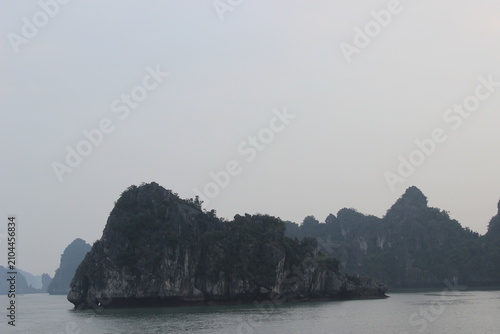 Majestic limestone karst islands surrounded by peaceful sea waters in ha long bay.