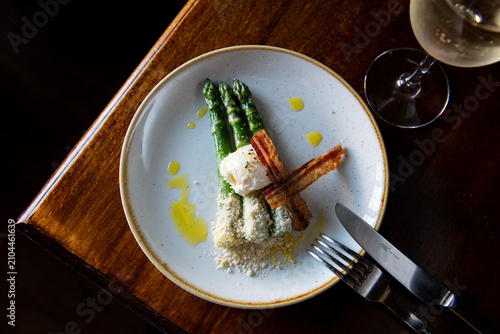 Delightful Asparagus Dish With Crispy Bacon and Rich Sauce Served at a Cozy Dining Spot