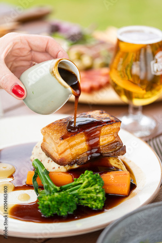 Fotografía Delicious Gourmet Pork Belly Served With Vibrant Vegetables and Rich Sauce