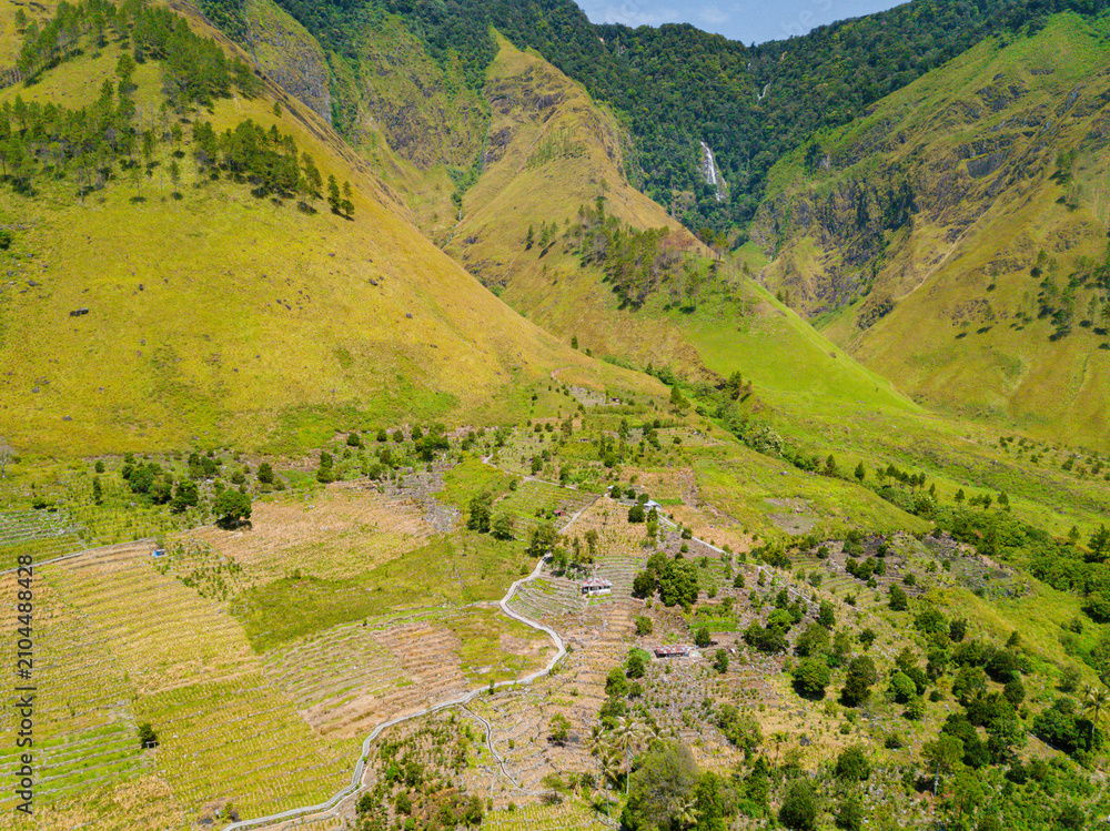 Fototapeta premium Aerial drone view of lush greenery hills near Toba Lake at Silalahi in Desa Binangara, Samosir, Sumatra Utara, Indonesia