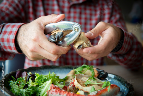 Enjoying a Delicious Seafood Feast With a Shellfish Cracker at a Cozy Restaurant