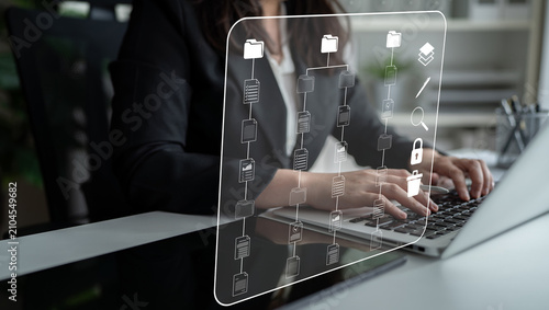 Business Professional Working on Laptop with Digital File Management Interface for Productivity and Organization in Modern Office Environment. Sentient.