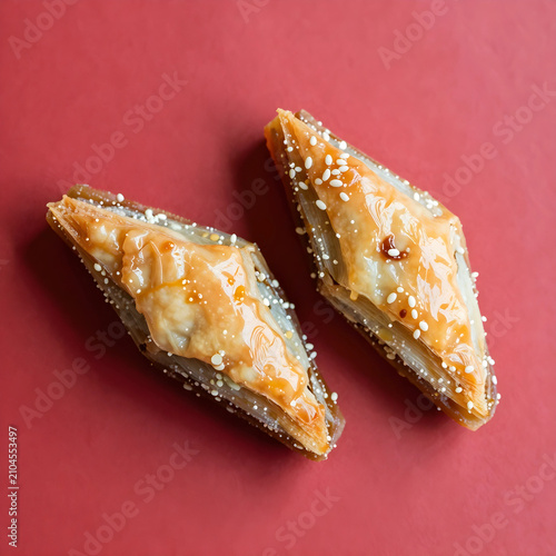 Two pieces of baklava on re...