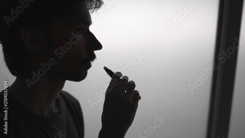 Cuadro en lienzo Person Inspects Vapor Production Quality And Flavor Profile Near Window While Reviewing Device