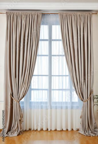 Elegant beige curtains with...