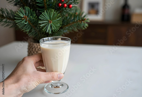 Hand holding a glass of cre...