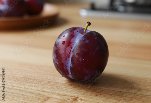 Ripe plum with water drople...