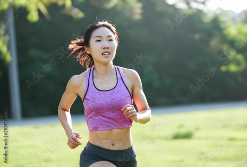 Young asian woman running o...