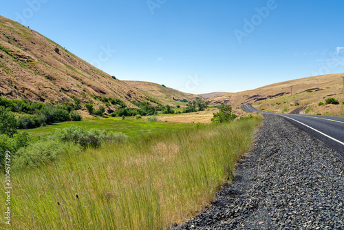 Willow Creek Road curves between the rolling hills of northeastern Oregon, United States