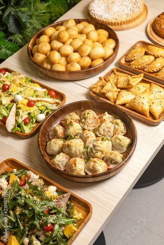 Traditional central asian feast table with manti dumplings baursak and samsa pastries