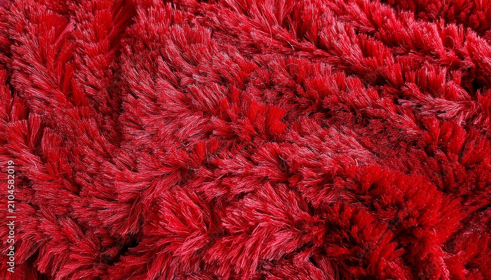 Fototapeta premium full frame macro of vivid red shag carpet with dense plush curled yarn texture