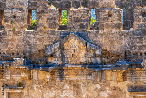 Weathered stone facade and architectural details of the ancient Roman theater at Aspendos in Antalya Province, Turkey.