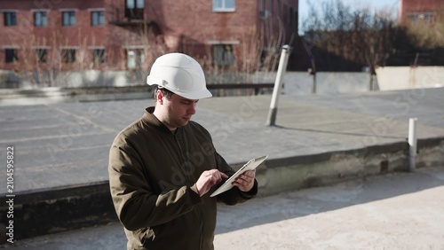 Worker Reviews Safety And Damage. Urban Construction Site With Safety Inspection And Accident Overview. Media