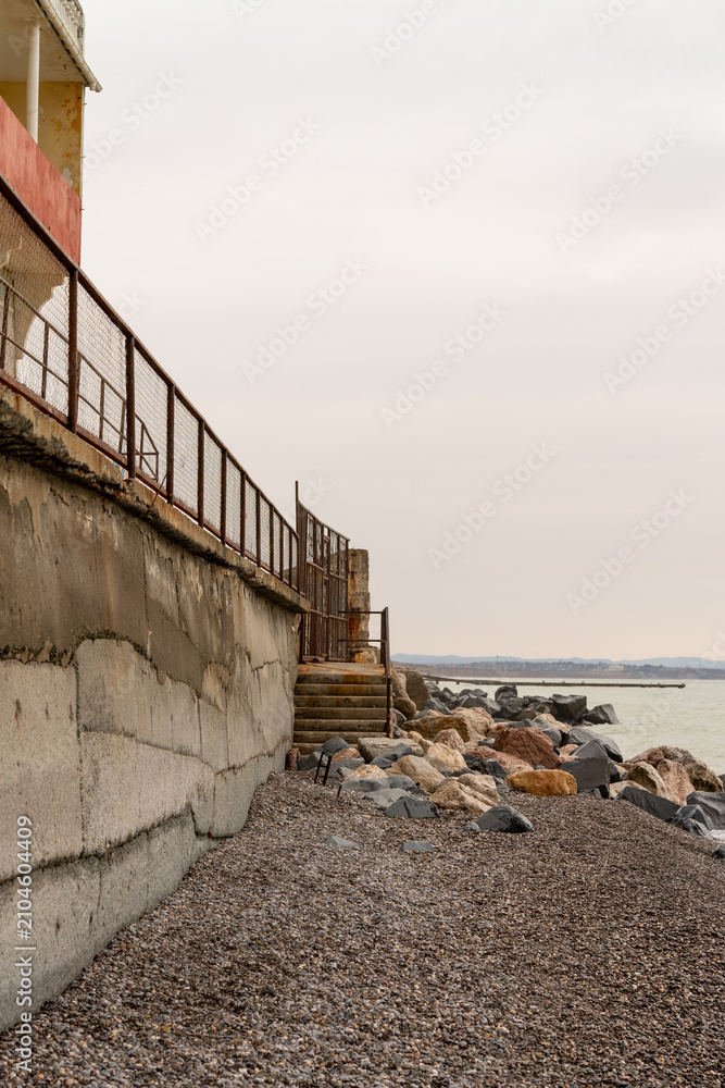 Fototapeta premium Coastal protection structure by the sea. Vertical photo.